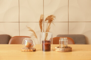 Stylish decor with candle on wooden table in dining room