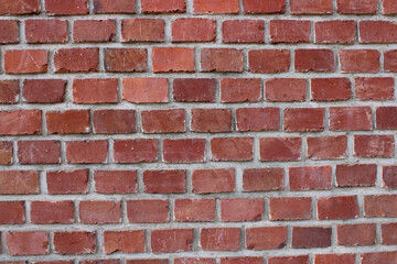 A typical red brick wall of a building holding together using mortar.