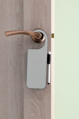 Closed door with hanger in hotel room, closeup