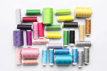 Multicolored sewing thread spools on white background