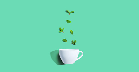 Fresh mints with tea cup overhead view - flat lay