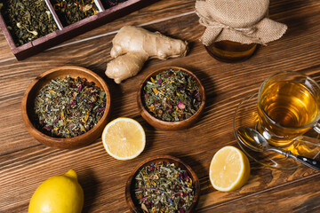 Obraz na płótnie Canvas Top view of tea, lemons and honey on wooden surface.