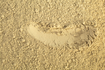 Close up of green natural bentonite clay powder for face mask, face cream, body wrap, selective focus. Abstract background