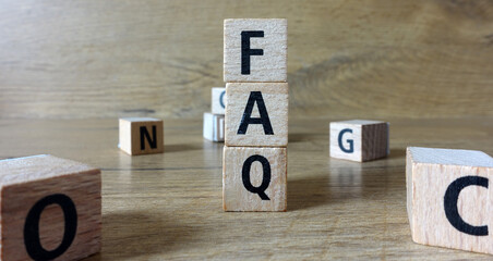 FAQ word made of wooden letters.