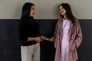 Two adult Latin American women mother and daughter having a relaxed conversation. Concept generations and mother's day