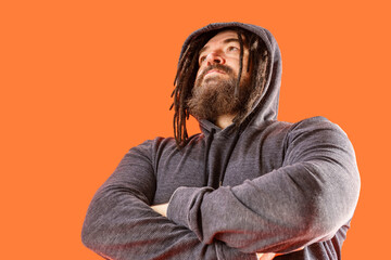 Obraz premium Menacing appearance. A dangerous man with a mohawk and dreadlocks covered with a hood. A middle-aged man with a beard and an unusual hairstyle