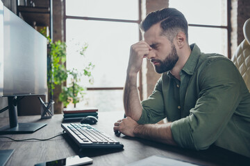 Profile side view portrait of attractive tired guy writing solving task developing project touching...