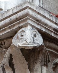 Closeup of a fish gargoyle on the pillar at the Rialto fish market in Venice