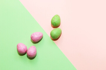 Multi-colored Easter decorative eggs on a pastel background.
