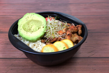 Poke or Bowl of sweet and sour pork, accompanied by zucchini, tomato, quinoa rings, mushrooms, Chinese roots, lettuce and pepper