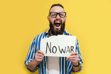 Portrait of men protesting against the war in Ukraine holds a sign in his hands message no war