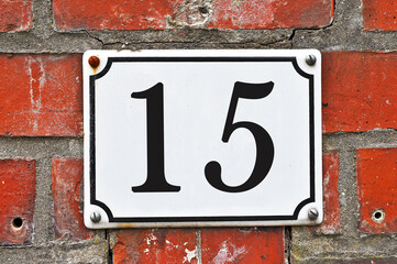 White house number plaque, showing the number fifteen