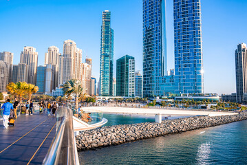 Address Jumeirah Beach resort hotel with pedestrian bridge and city skyscrapers