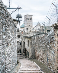 Staircase between buildings on a gloomy day in old town Assisi, Italy