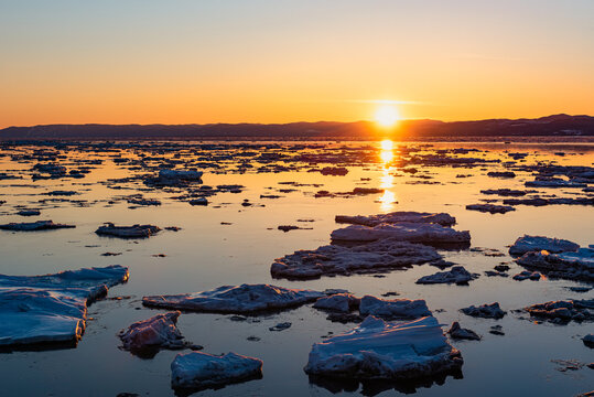 At the sunset, floting ice on the Saint-Lawrence river at Rivi&egrave;re-Ouelle in the Kamouraska (Quebec, Canada).