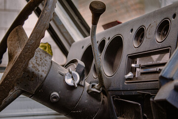 Dashboard and steering wheel in an old car, side photo