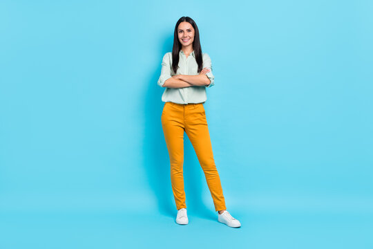 Full body photo of young cheerful woman crossed hands representative isolated over blue color background
