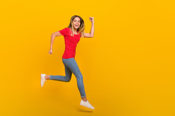 Fototapeta na wymiar Full size profile side photo of young girl runner hurry motion speed jump discount isolated over yellow color background