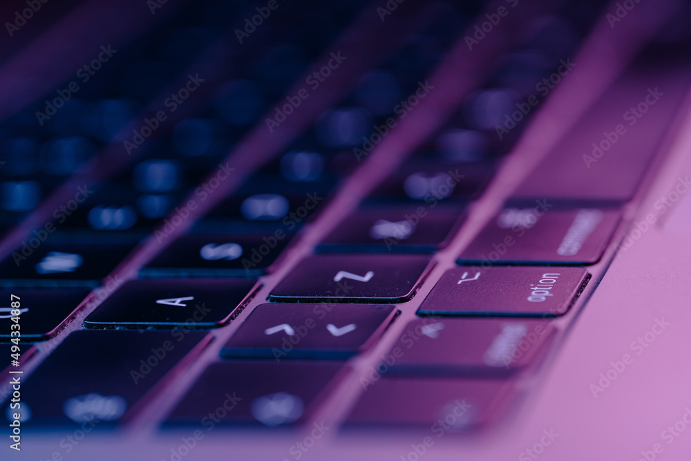 Poster closeup of an electronic keyboard with glowing buttons with purple theme light