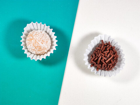 Coconut Candy and Brigadier's sweet (Beijinho and Brigadeiro, in portuguese) on blue and white background. Brazilian Handmade candies.