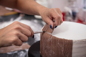 Person decorating a cake with marzipan