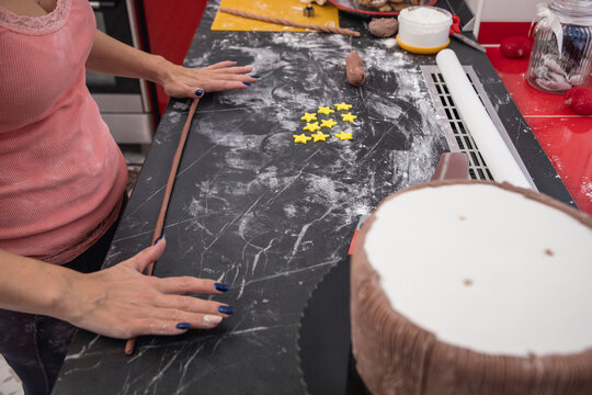 Photo of woman making beautiful custom cake