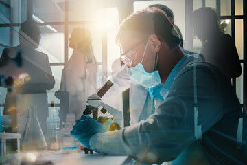 Doctor in the laboratory analyzes samples of codiv-9 under a microscope