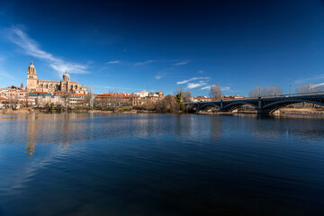 Salamanca skyline view with Cathedral and Enrique Estevan Bridge on Tormes River, Spain