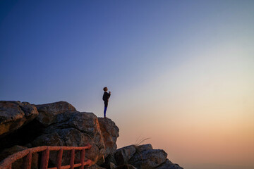 Young Caucasian yogini woman on a clifftop in Mysore, India