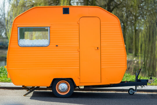 Small orange caravan outdoors