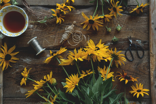 Overhead Shot Of Yellow Flowers On Rustic Wooden Table