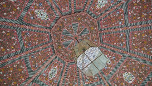 Decorative colorful pattern ceilings with lamp in Morocco, rotate handheld view