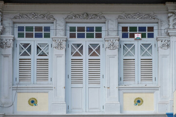 Straits Chinese Peranakan exterior with wooden louvers, rococo designs and peacock mosaic tiles