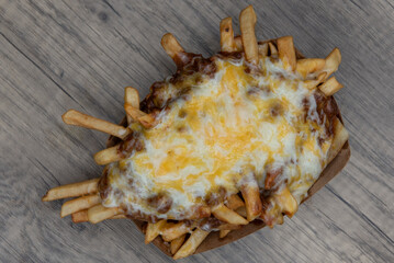 Overhead view of huge calorie consumption with this side order of chili cheese fries served in a...