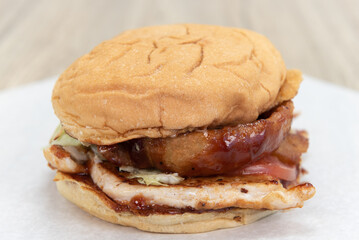 BBQ sauce dripping off the onion ring of the chicken sandwich