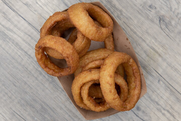 Overhead view of side order appetizer of deep fried onion rings always tastes wonderful to eat