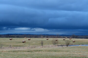 Fototapeta na wymiar Storm Clouds Over a Hay Field