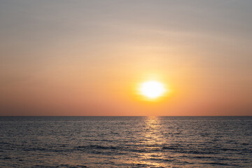 Sunset into the sea with twilight sky
