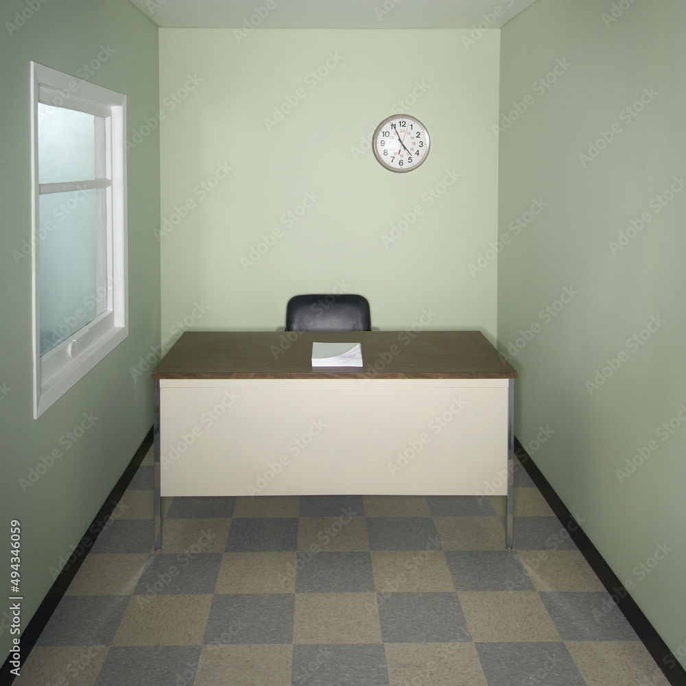 Poster closeup of papers on the table with a clock in a room