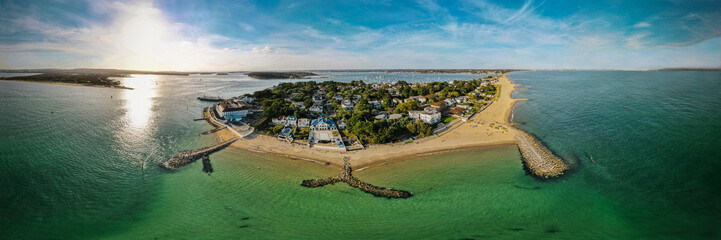 Aerial view of Bournemouth town of Sandbanks peninsula with a crystal clear water and a sunny sky