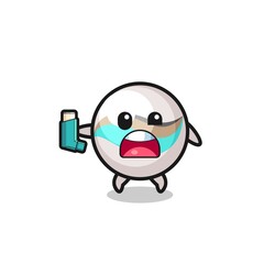 Fototapeta premium marble toy mascot having asthma while holding the inhaler
