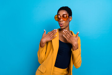 Portrait of astonished nice person plump lips raise hands unbelievable isolated on blue color...