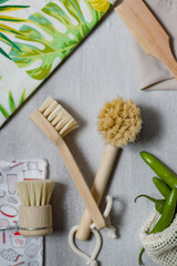 Ecological brushes, made of wood with natural bristles, a bag with embroidered plants and green and yellow colors and a bag with serrano peppers.