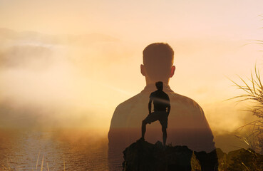 Strong determined man standing on mountain peak. Win goal setting and victory concept 