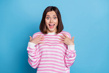 Photo of impressed millennial brunette lady wear striped pullover isolated on blue background