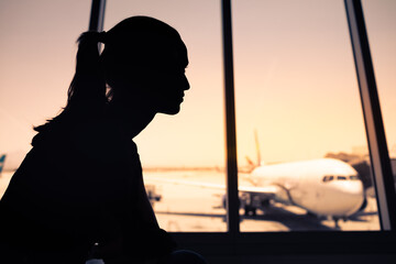 silhouette of a young female sitting airport 