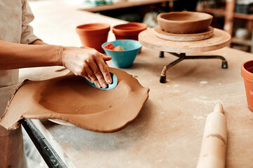 I have to smooth it out first. Cropped shot of an unrecognizable artisan working in a pottery workshop.