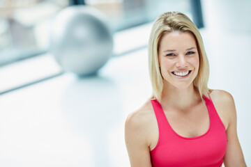 The gym is my second home. Cropped portrait of an attractive young woman in workout attire.