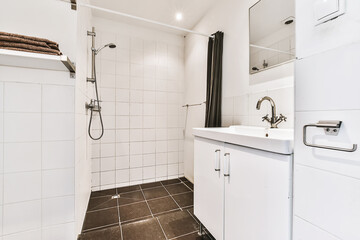 Nice bathroom with dark tiled floor and shower