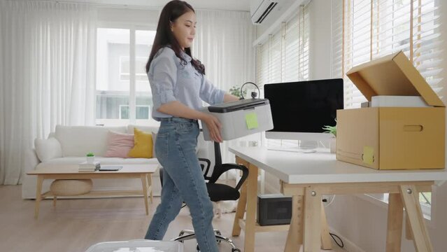 Future of workforce remote work fully permanent. Asia people happy relax move job to new small workspace set up desk picking file folder from box. Keep it chores neat start long term plan career work.